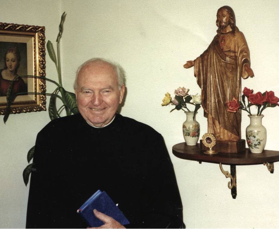 Father Frank beside statue